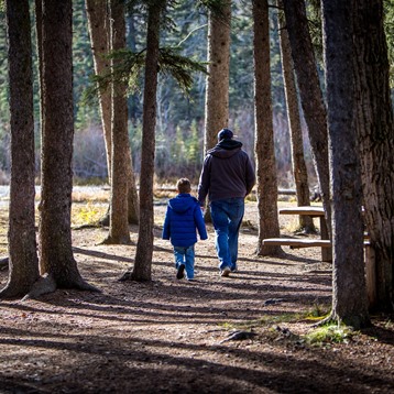 man and boy hiking in a park